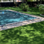 Artificial grass surrounding pool